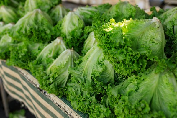 How can lighting enhance the perception of space in a UK kitchen?